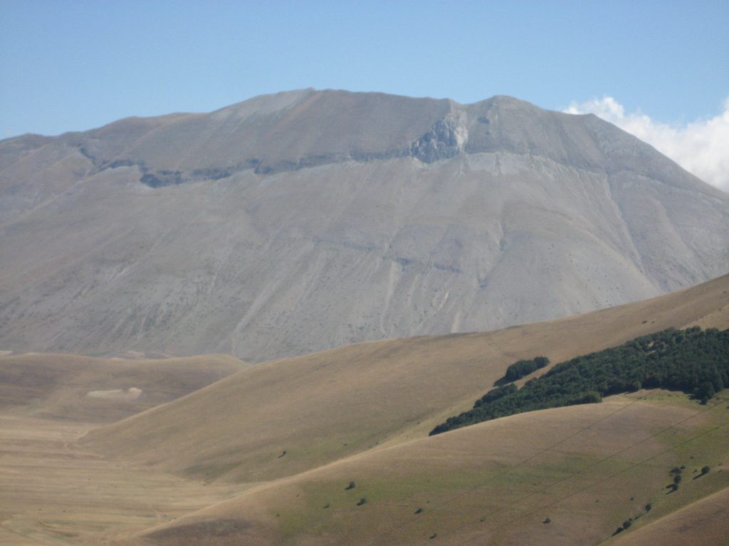 The high plateau of Castelluccio with the huge crack in the mountain chain