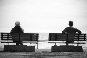 two people on two nearby benches