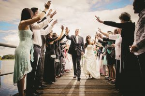 A couple walking through applauding people